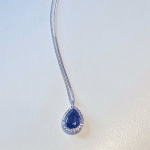 Givenchy with deep purple pendant necklace.